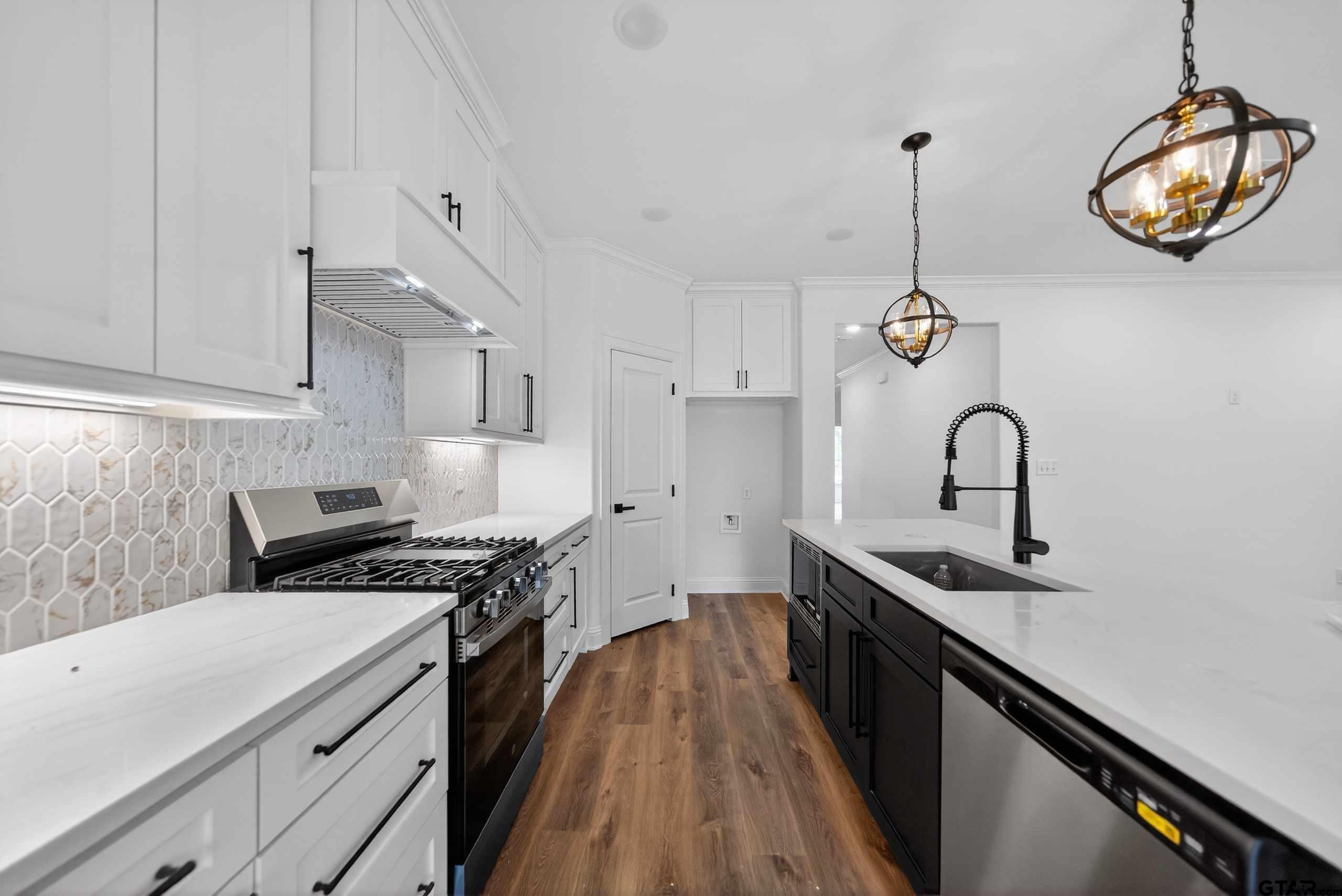 3045 Guinn Farms Road Tyler, TX 75707 - Photo 16 of 45 a kitchen with stainless steel appliances granite countertop a stove and a sink with dishwasher