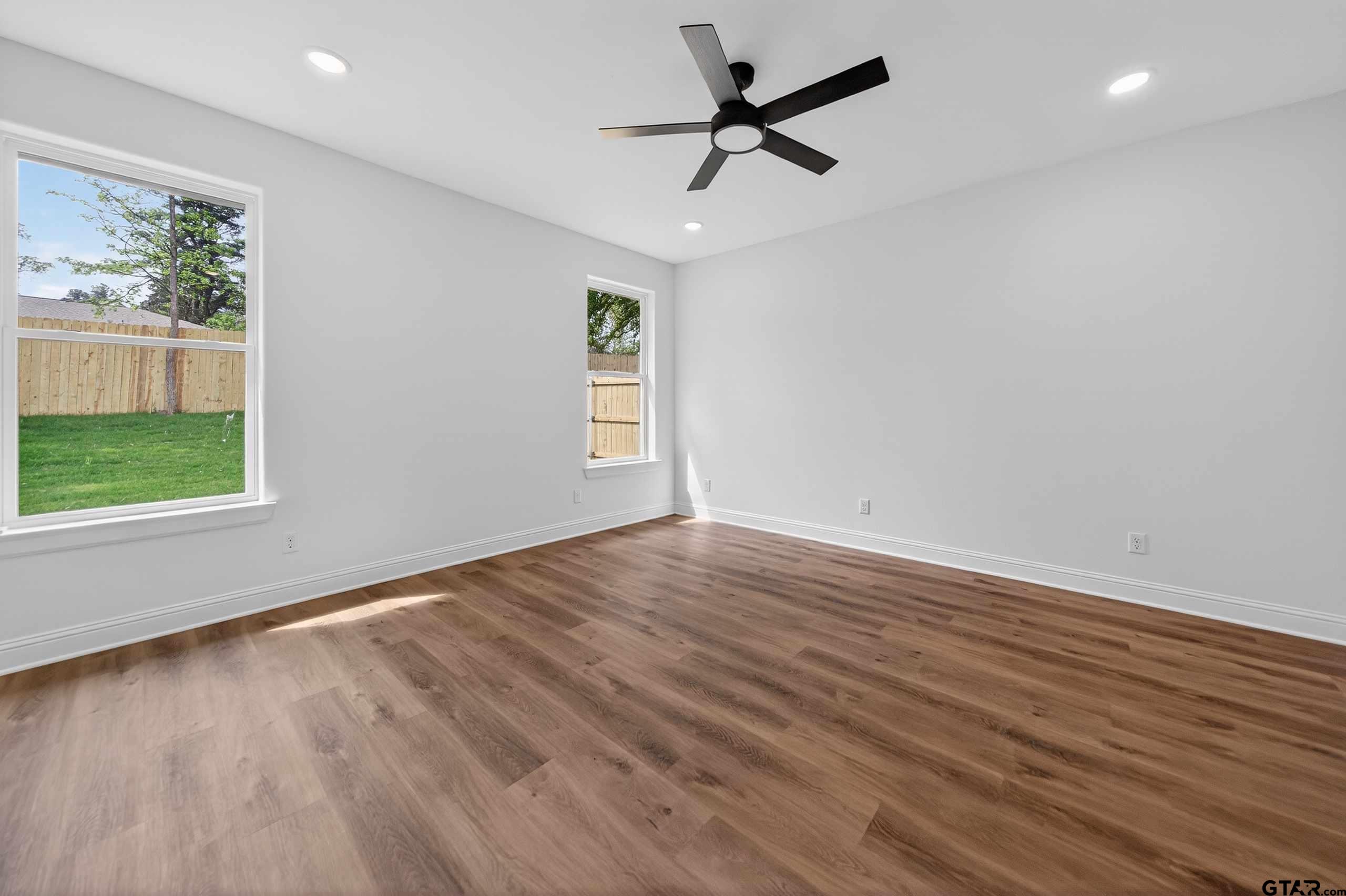 3045 Guinn Farms Road Tyler, TX 75707 - Photo 17 of 45 wooden floor in an empty room with a window