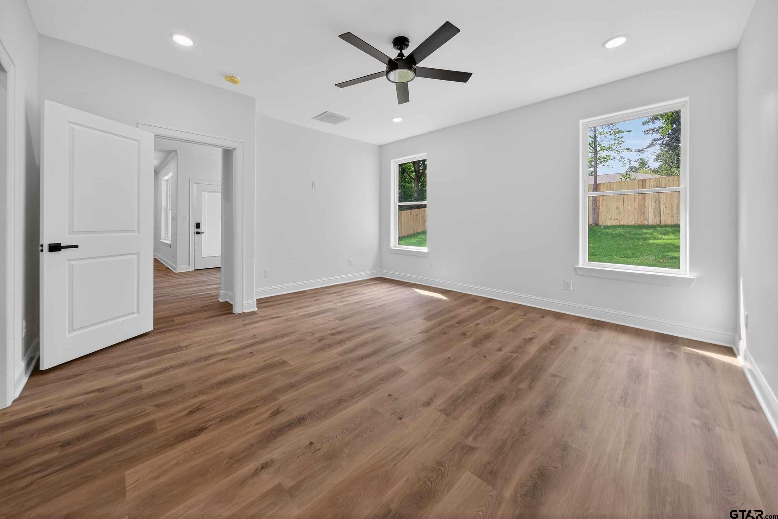 3045 Guinn Farms Road Tyler, TX 75707 - Photo 20 of 45 an empty room with wooden floor and windows