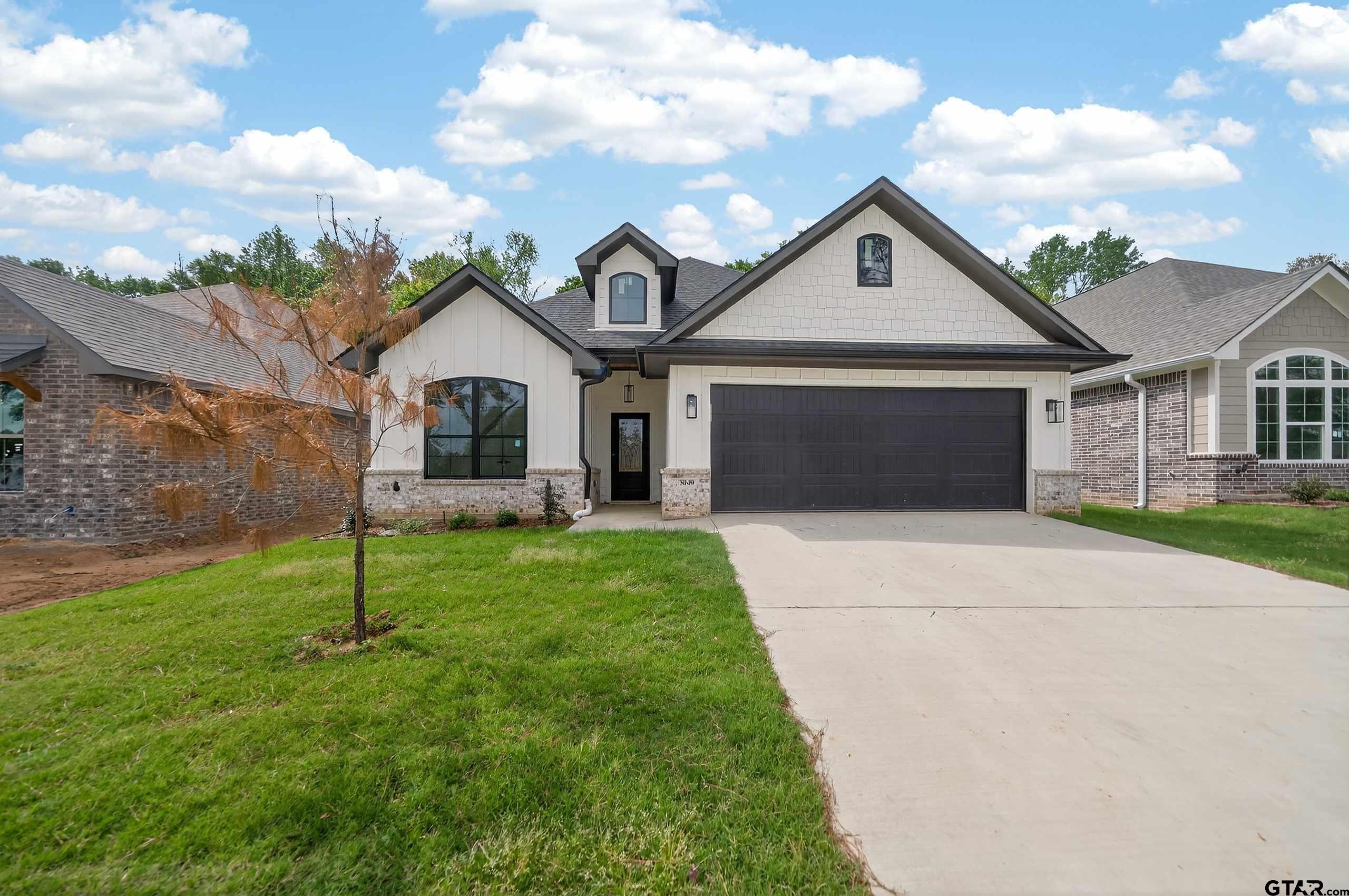 3045 Guinn Farms Road Tyler, TX 75707 - Photo 2 of 45 a front view of a house with a garden