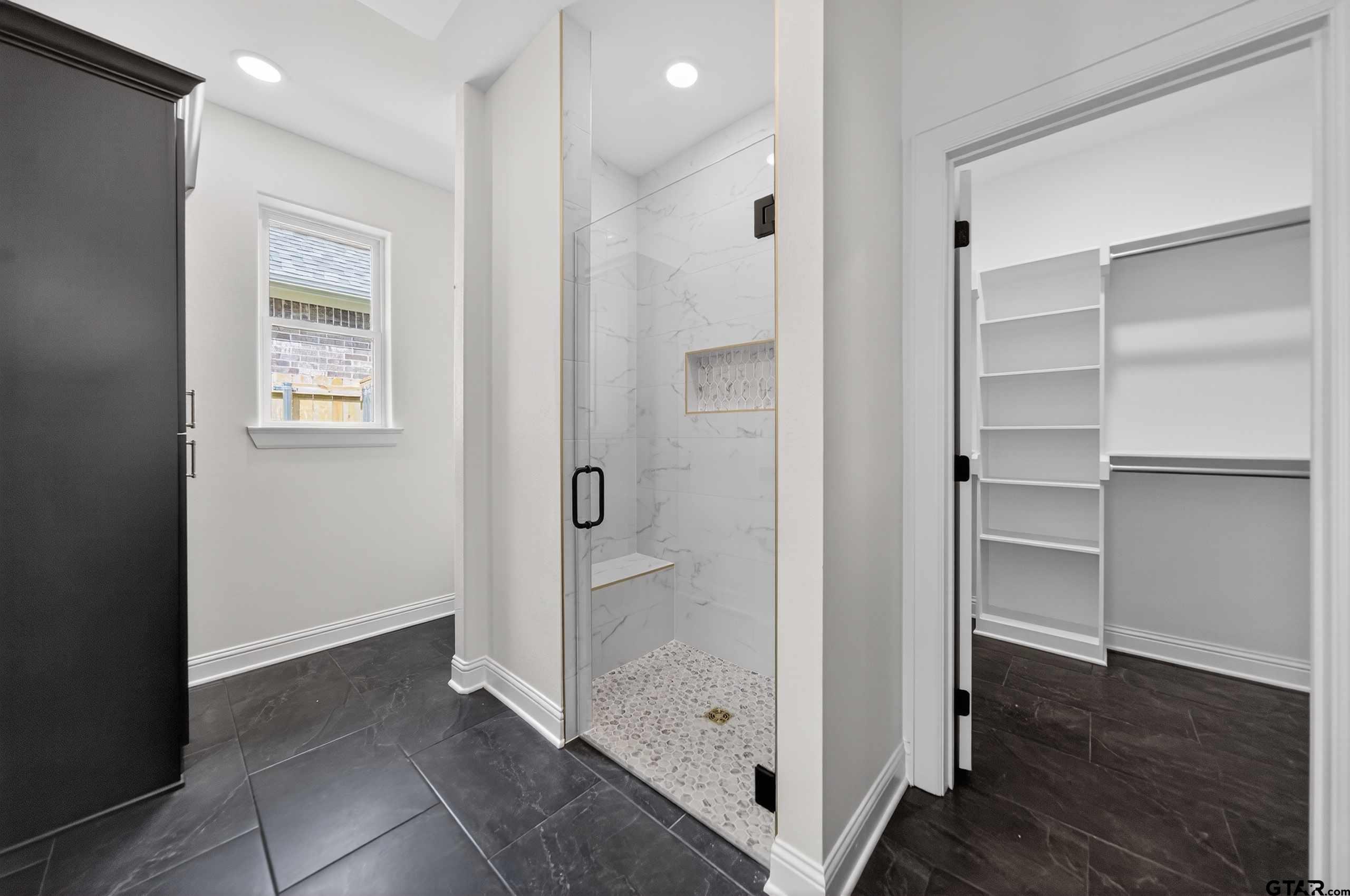 3045 Guinn Farms Road Tyler, TX 75707 - Photo 22 of 45 a bathroom with a shower and a sink