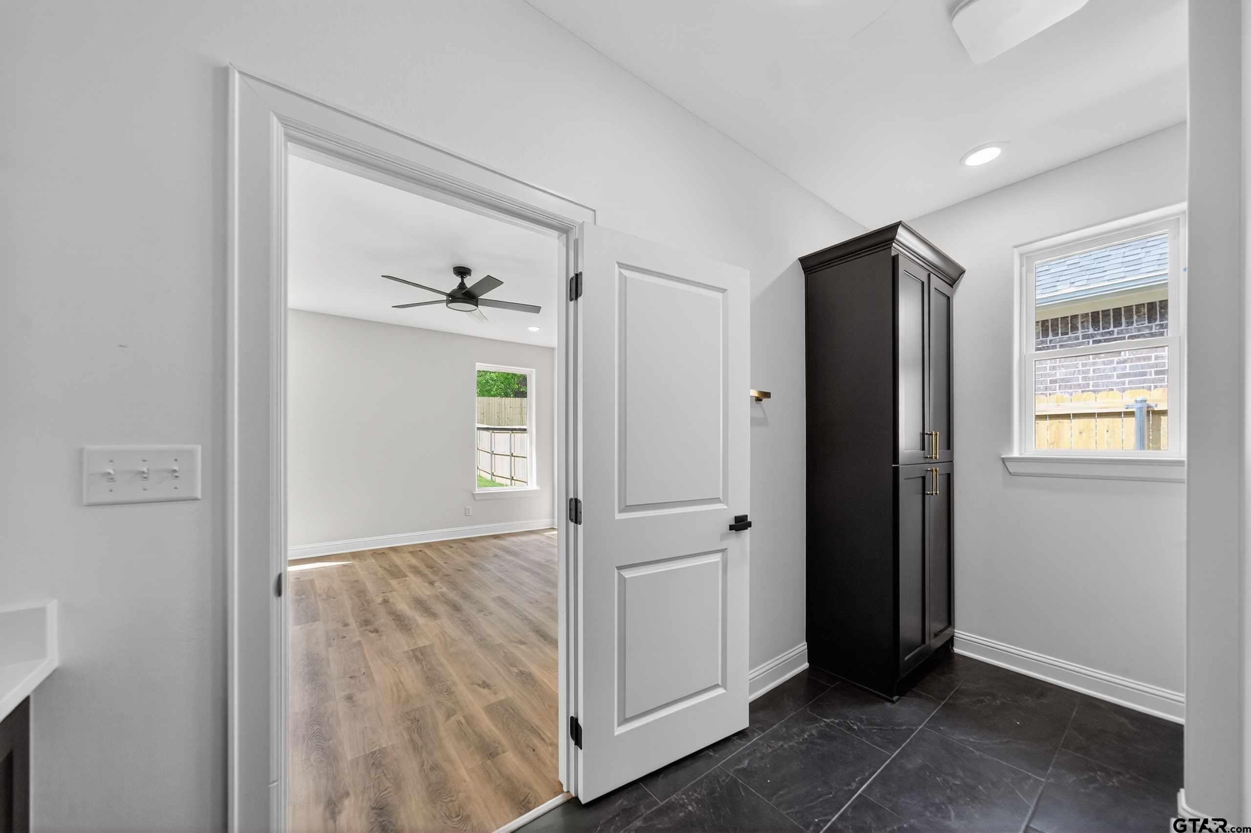 3045 Guinn Farms Road Tyler, TX 75707 - Photo 23 of 45 an empty room with windows and cabinet