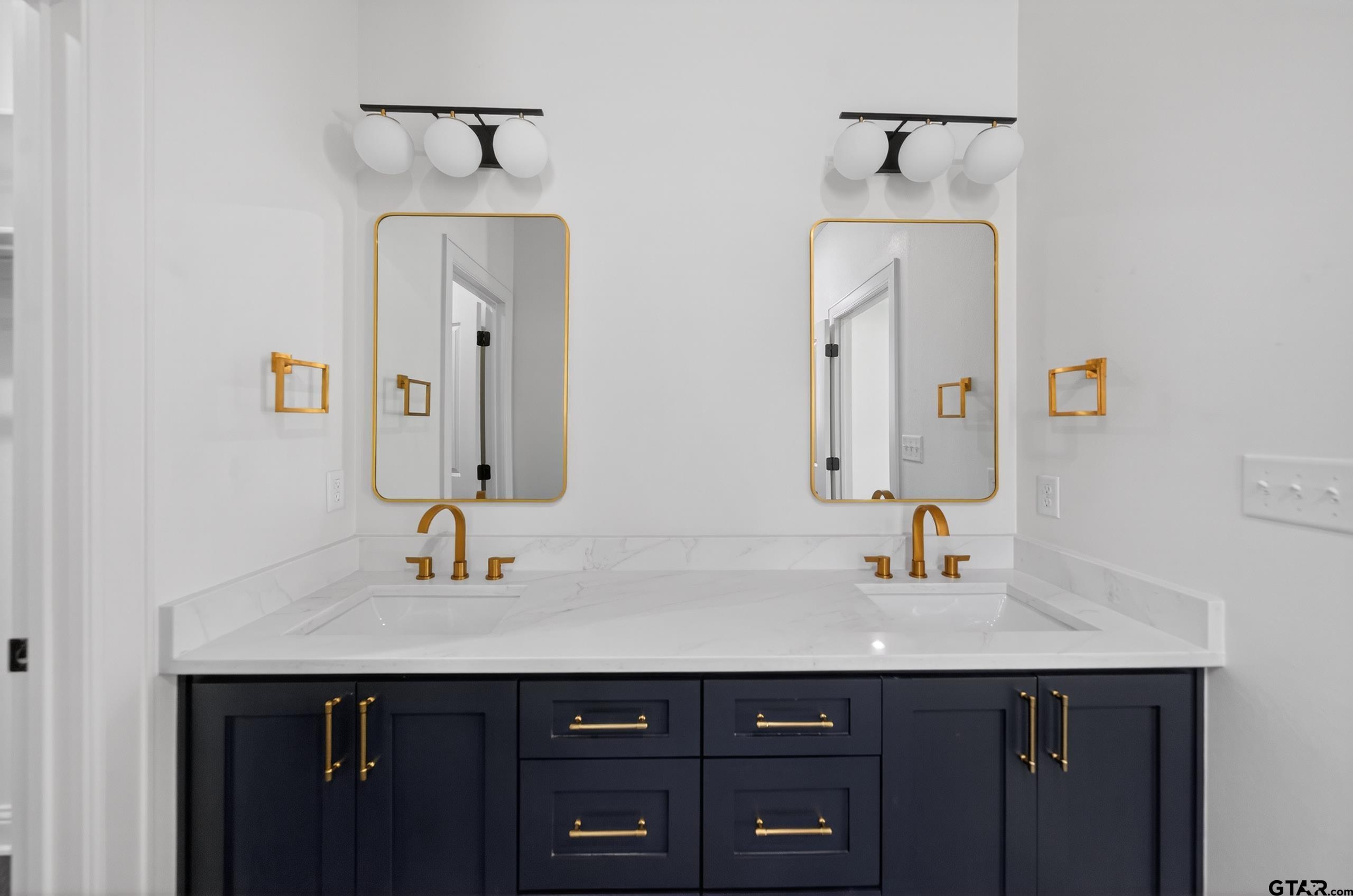 3045 Guinn Farms Road Tyler, TX 75707 - Photo 25 of 45 a bathroom with double vanity sink and a mirror