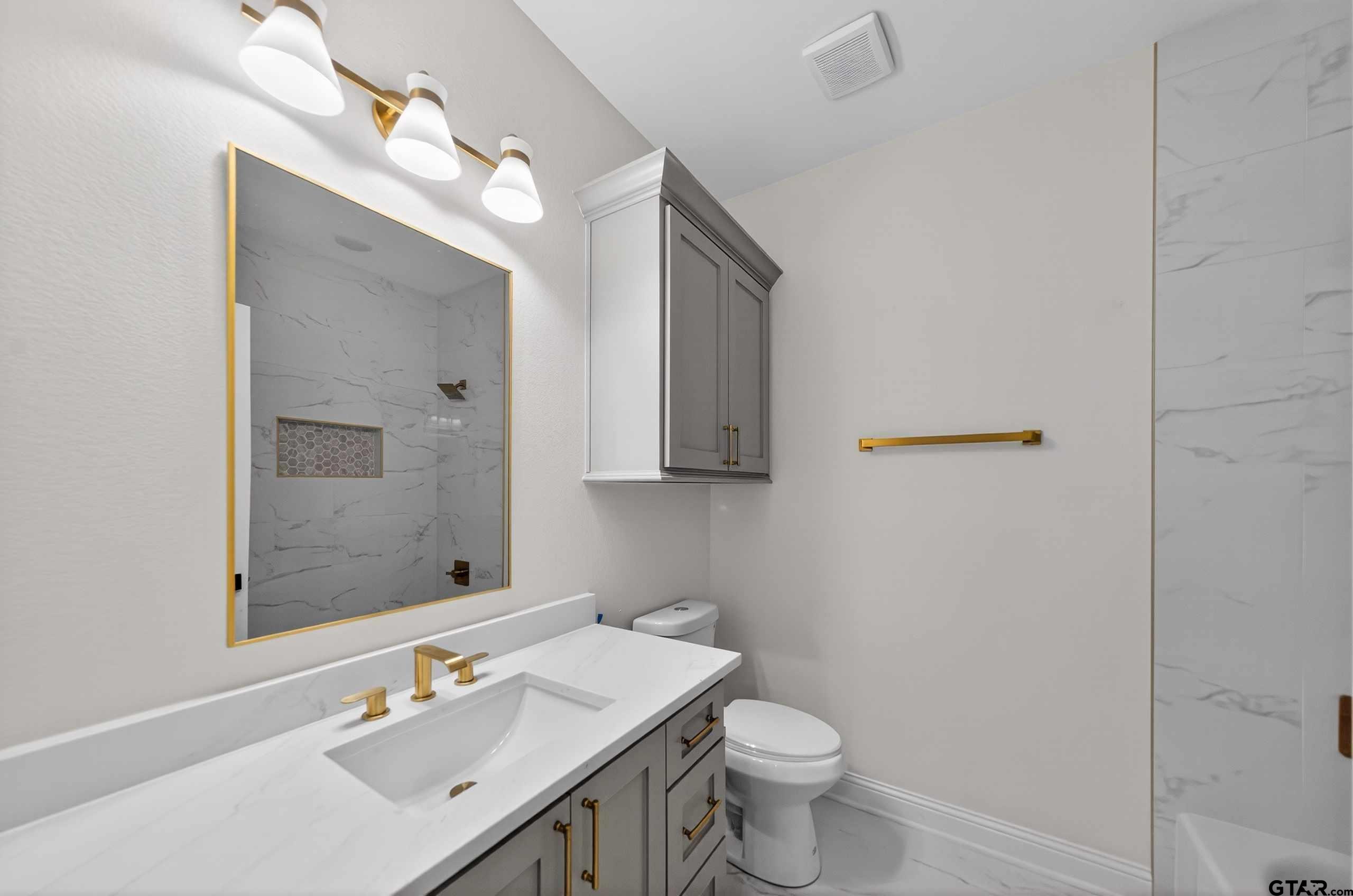 3045 Guinn Farms Road Tyler, TX 75707 - Photo 30 of 45 a bathroom with a sink toilet and shower