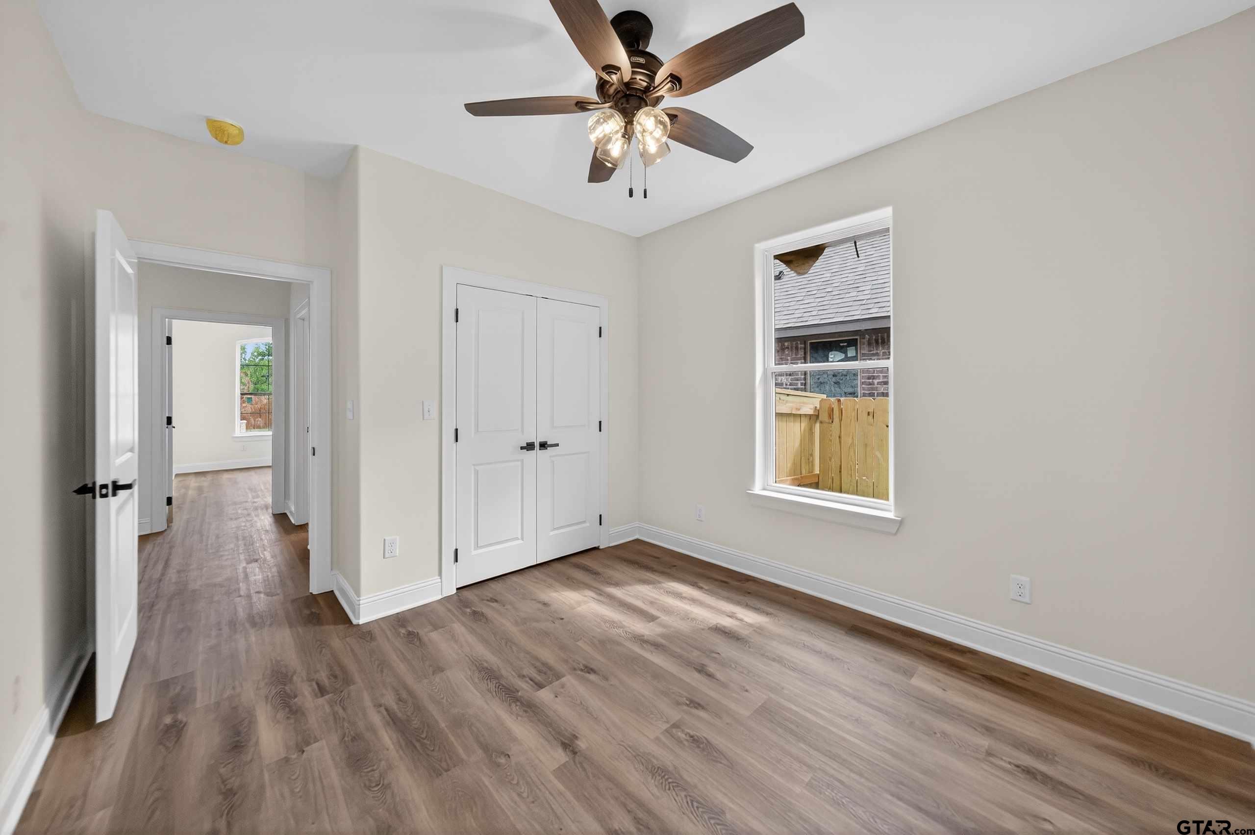 3045 Guinn Farms Road Tyler, TX 75707 - Photo 34 of 45 wooden floor in an empty room with a window