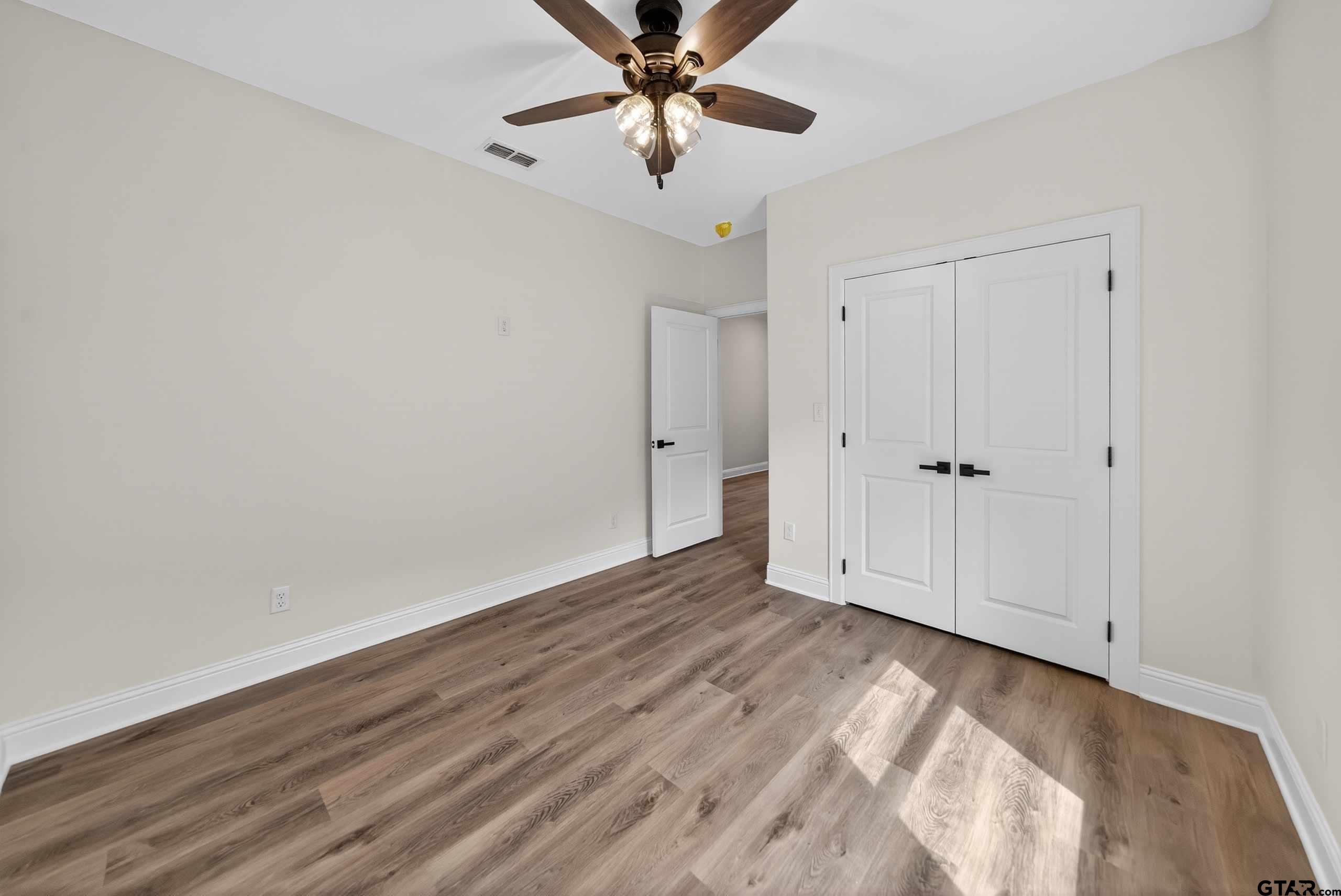 3045 Guinn Farms Road Tyler, TX 75707 - Photo 35 of 45 wooden floor in an empty room