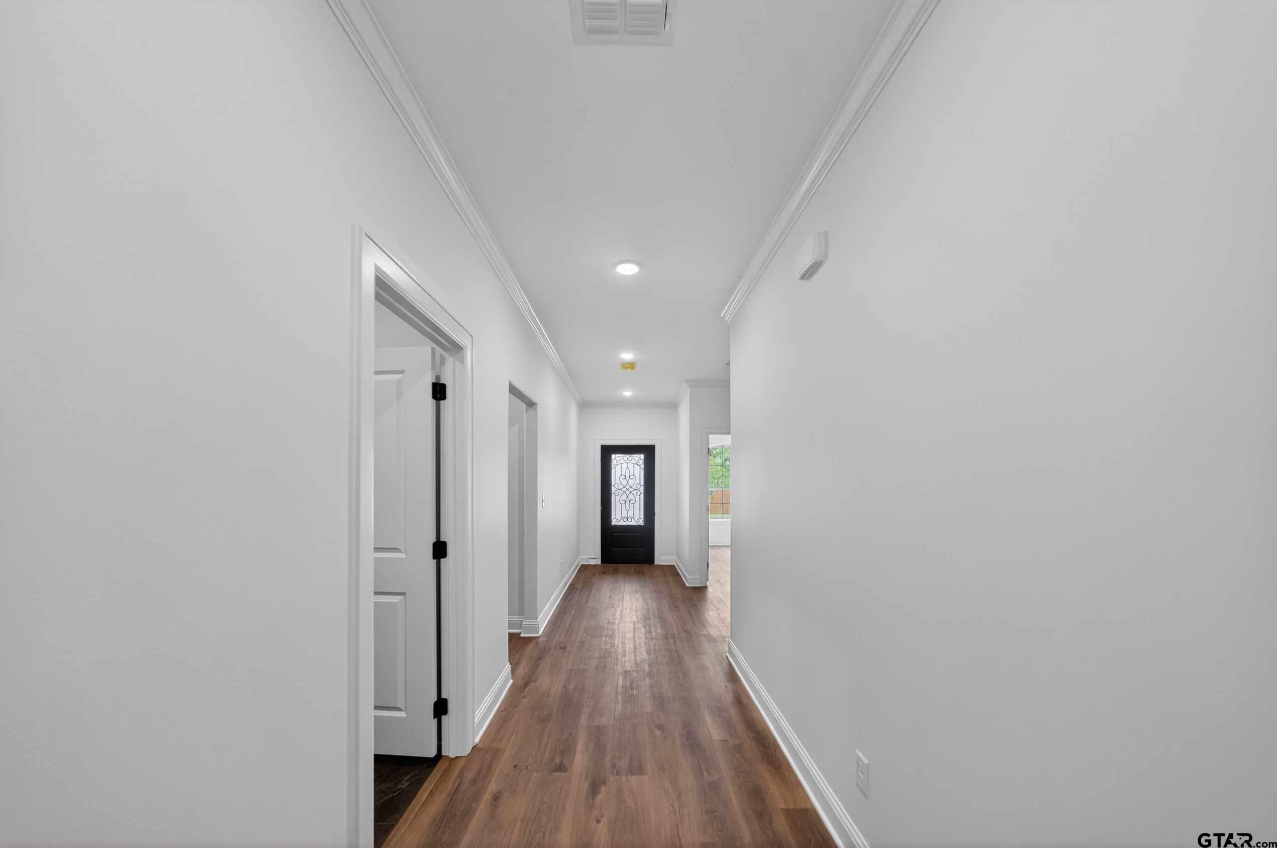 3045 Guinn Farms Road Tyler, TX 75707 - Photo 36 of 45 a view of a hallway with wooden floor