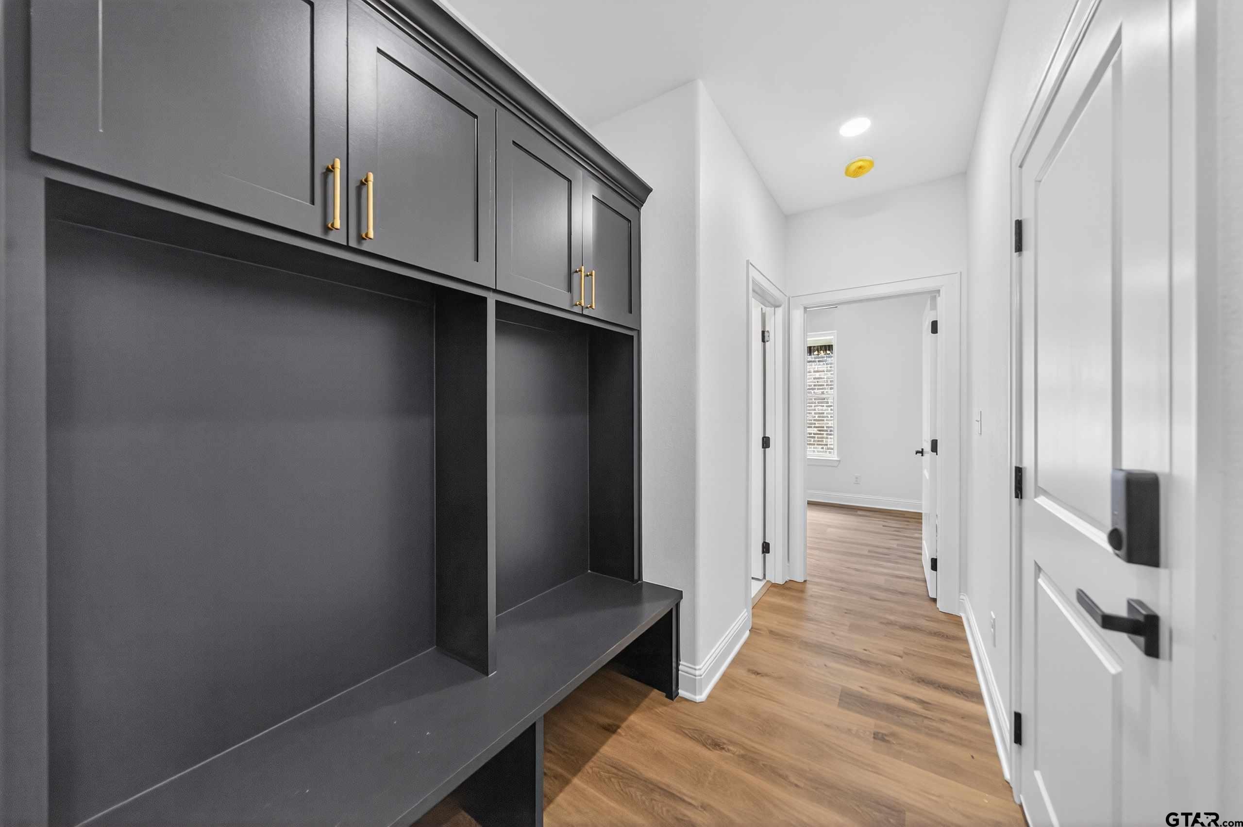3045 Guinn Farms Road Tyler, TX 75707 - Photo 38 of 45 a view of a hallway with wooden floor