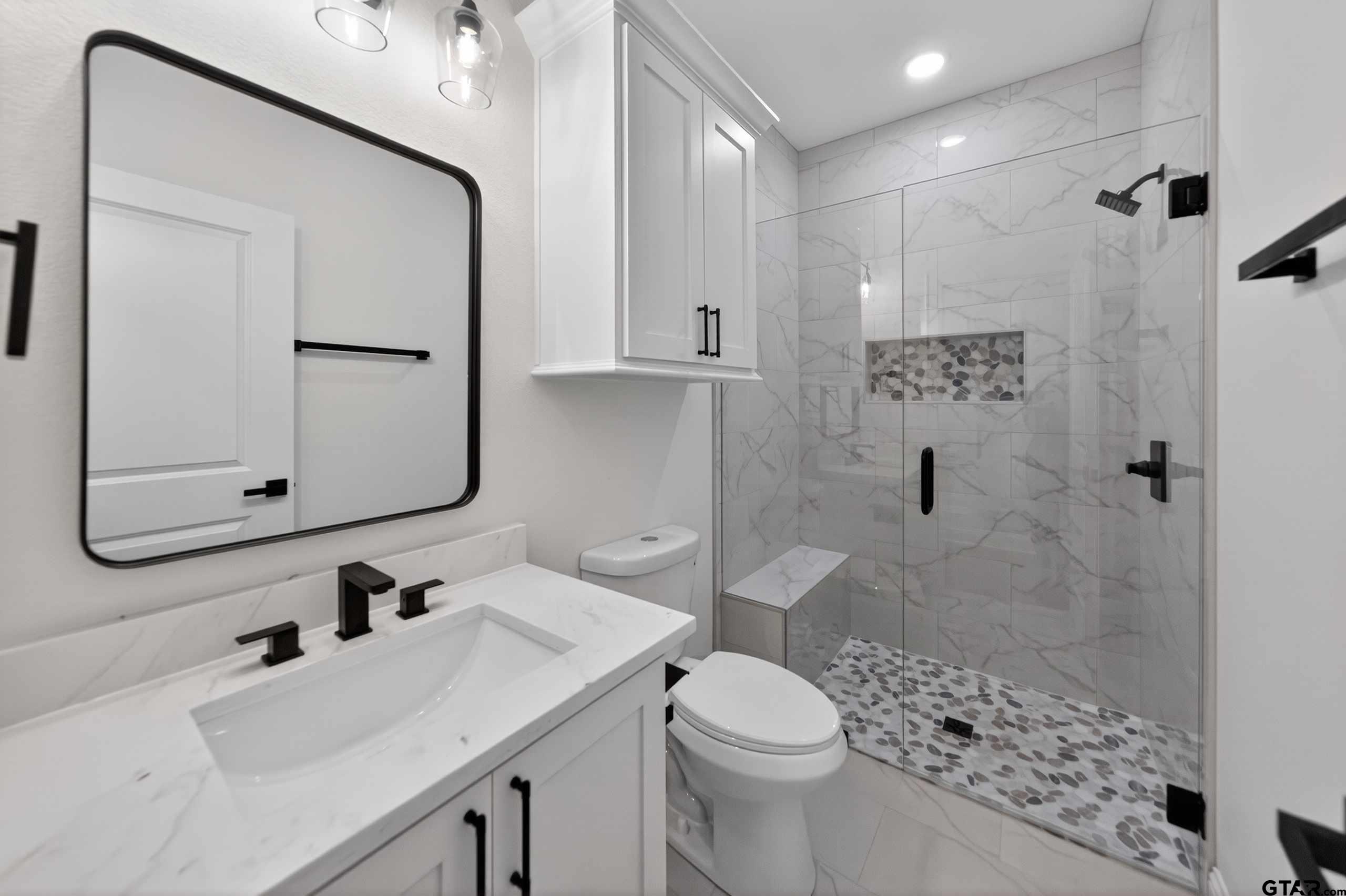 3045 Guinn Farms Road Tyler, TX 75707 - Photo 39 of 45 a bathroom with a sink a toilet and shower