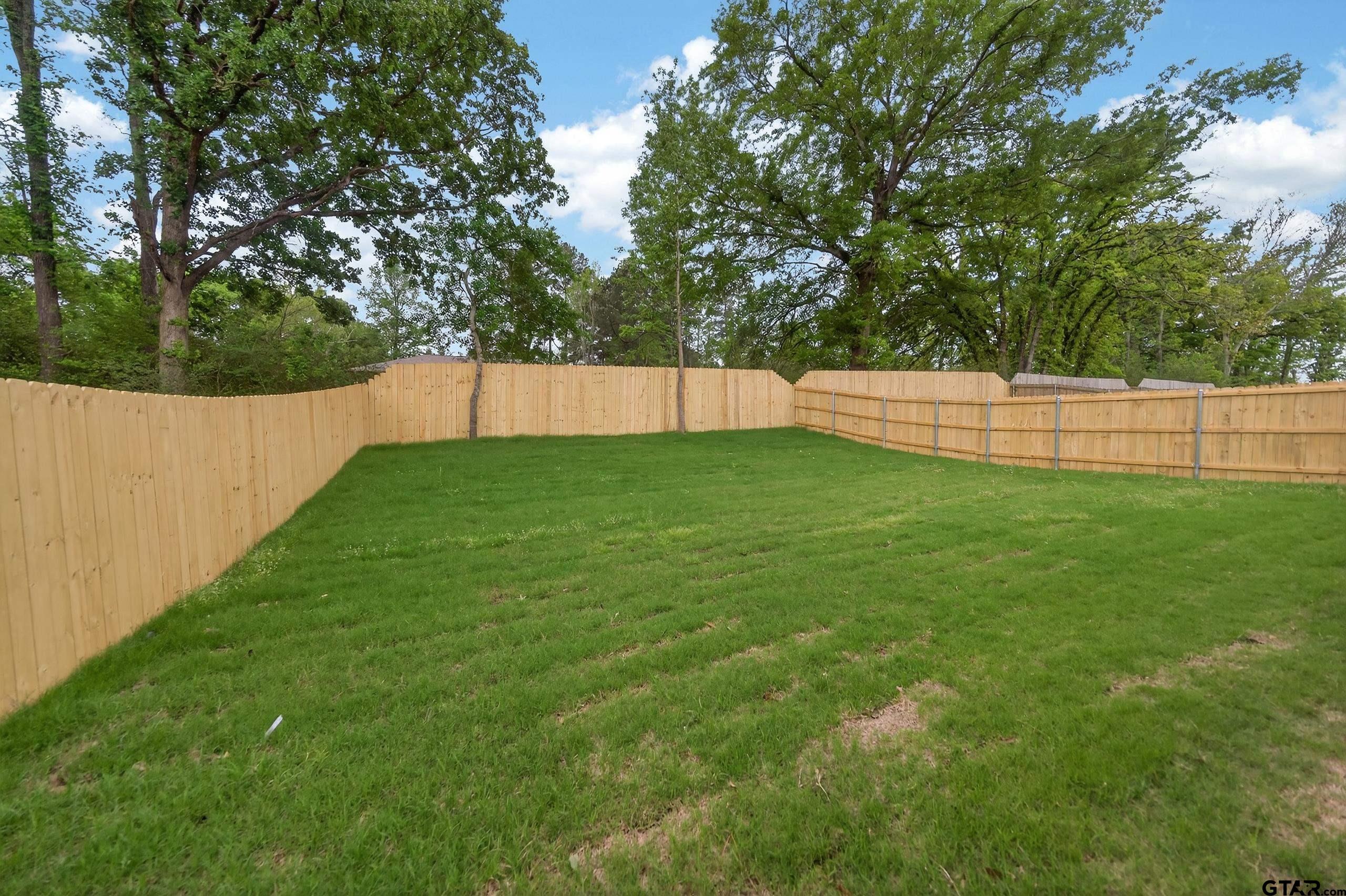 3045 Guinn Farms Road Tyler, TX 75707 - Photo 44 of 45 a view of a backyard with a small cabin