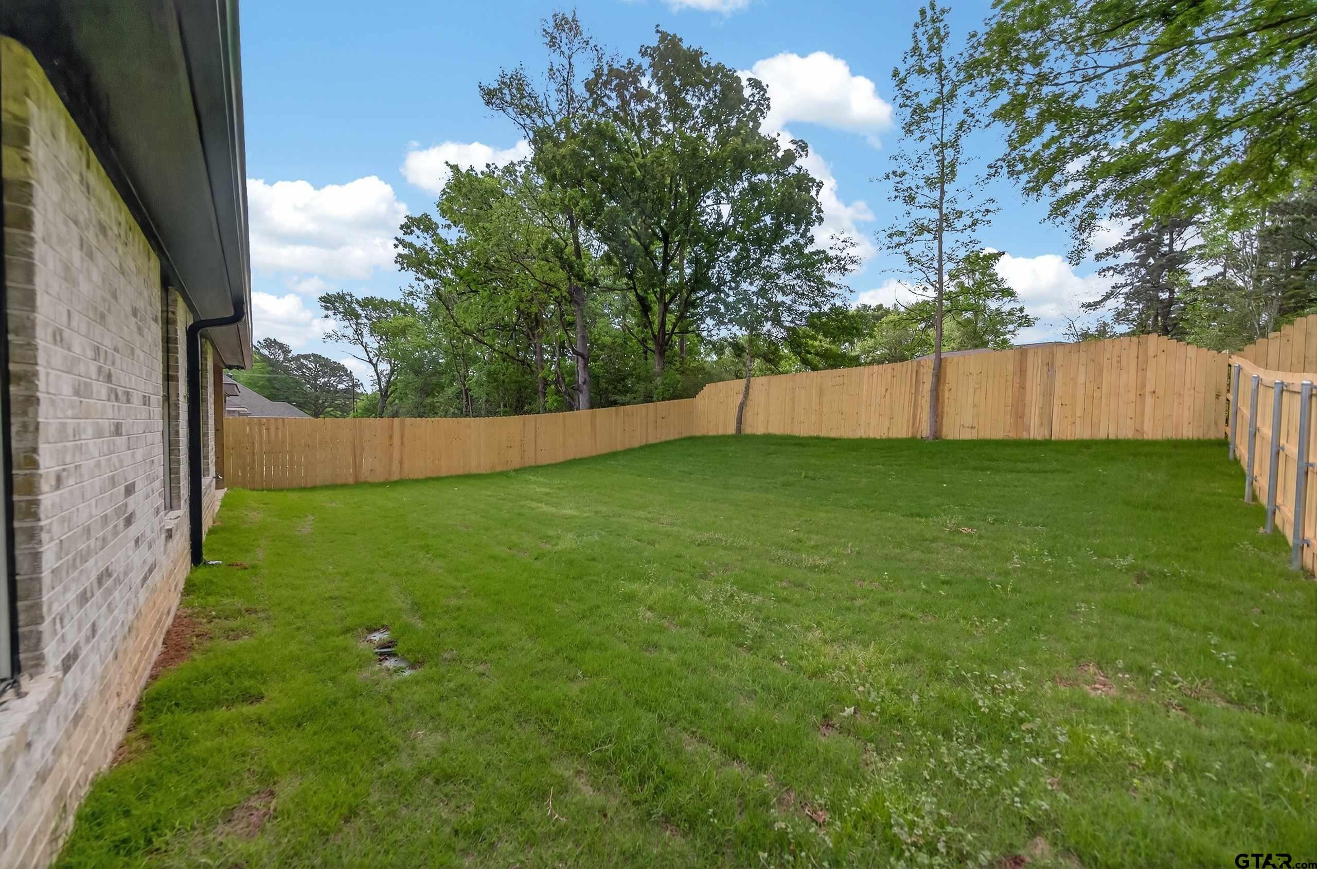 3045 Guinn Farms Road Tyler, TX 75707 - Photo 45 of 45 a view of a backyard with a small cabin