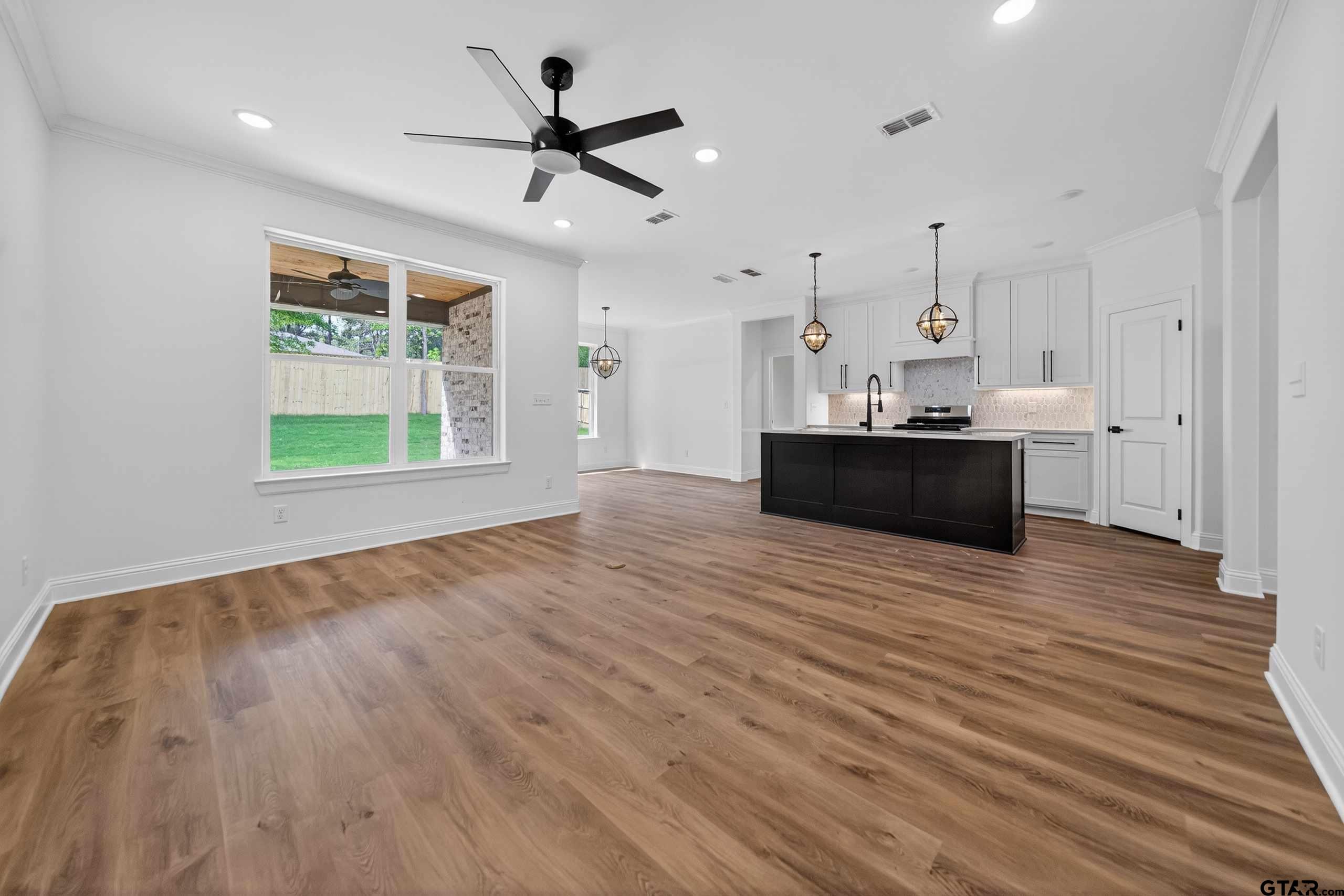 3045 Guinn Farms Road Tyler, TX 75707 - Photo 5 of 45 a view of a kitchen with a stove cabinets and wooden floor