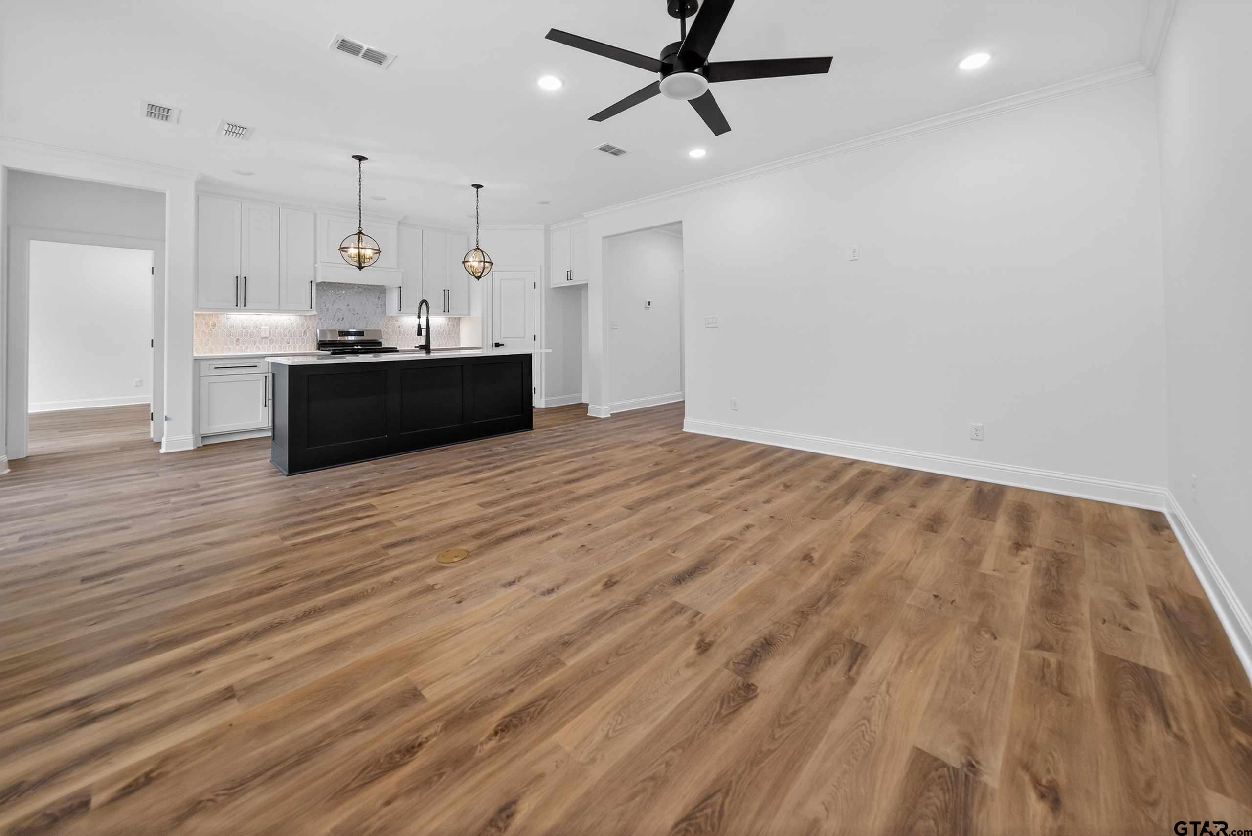3045 Guinn Farms Road Tyler, TX 75707 - Photo 6 of 45 a view of kitchen and empty room with wooden floor