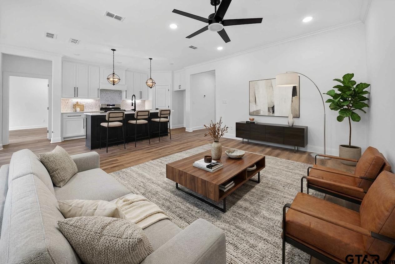 3045 Guinn Farms Road Tyler, TX 75707 - Photo 7 of 45 a living room with furniture fireplace and a potted plant