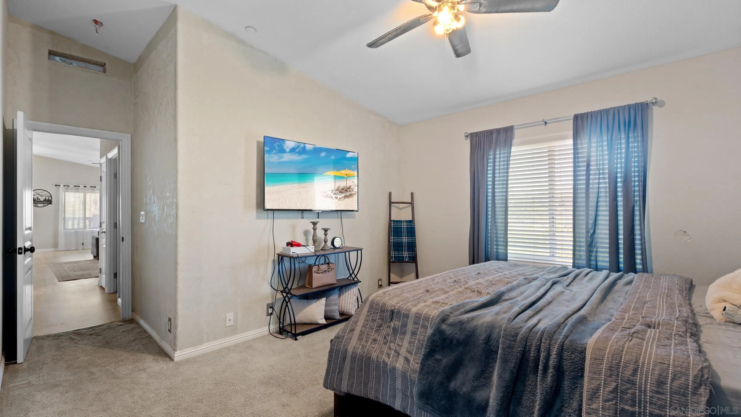 1140 Old Mountain View Road El Cajon, CA 92021 - Photo 11 of 25 a bedroom with a bed and a chandelier