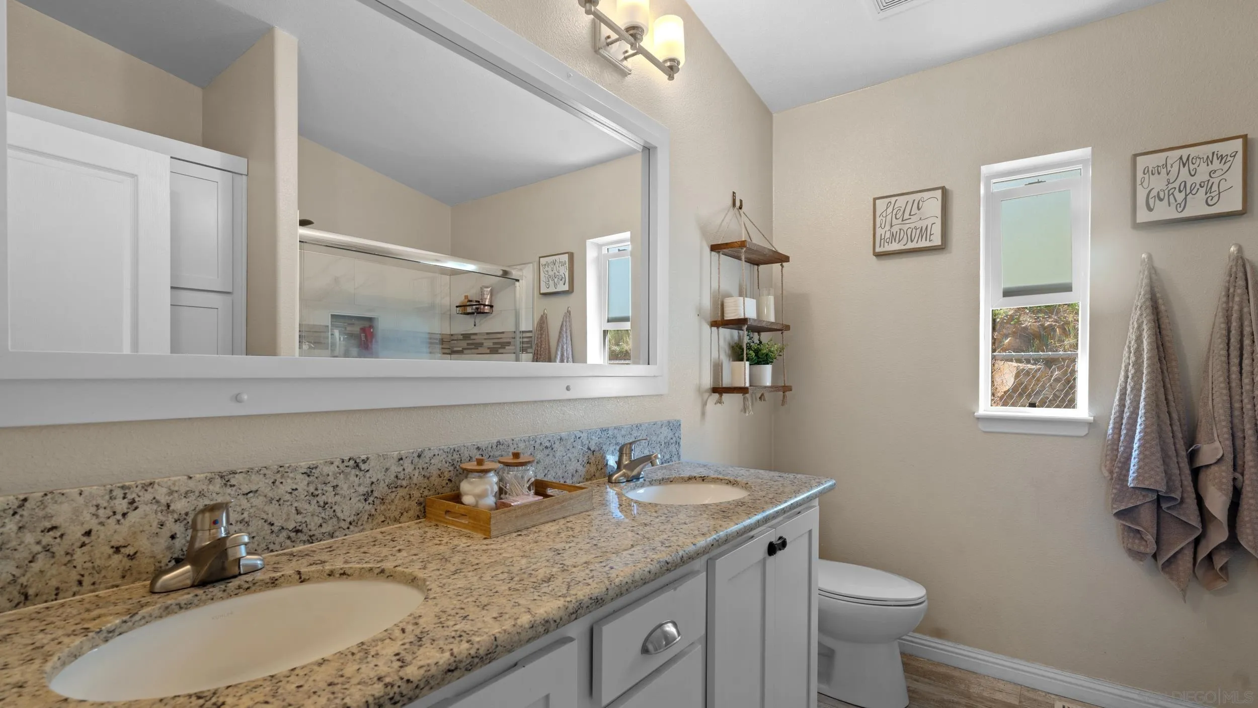 1140 Old Mountain View Road El Cajon, CA 92021 - Photo 12 of 25 a bathroom with a granite countertop sink a toilet and a mirror