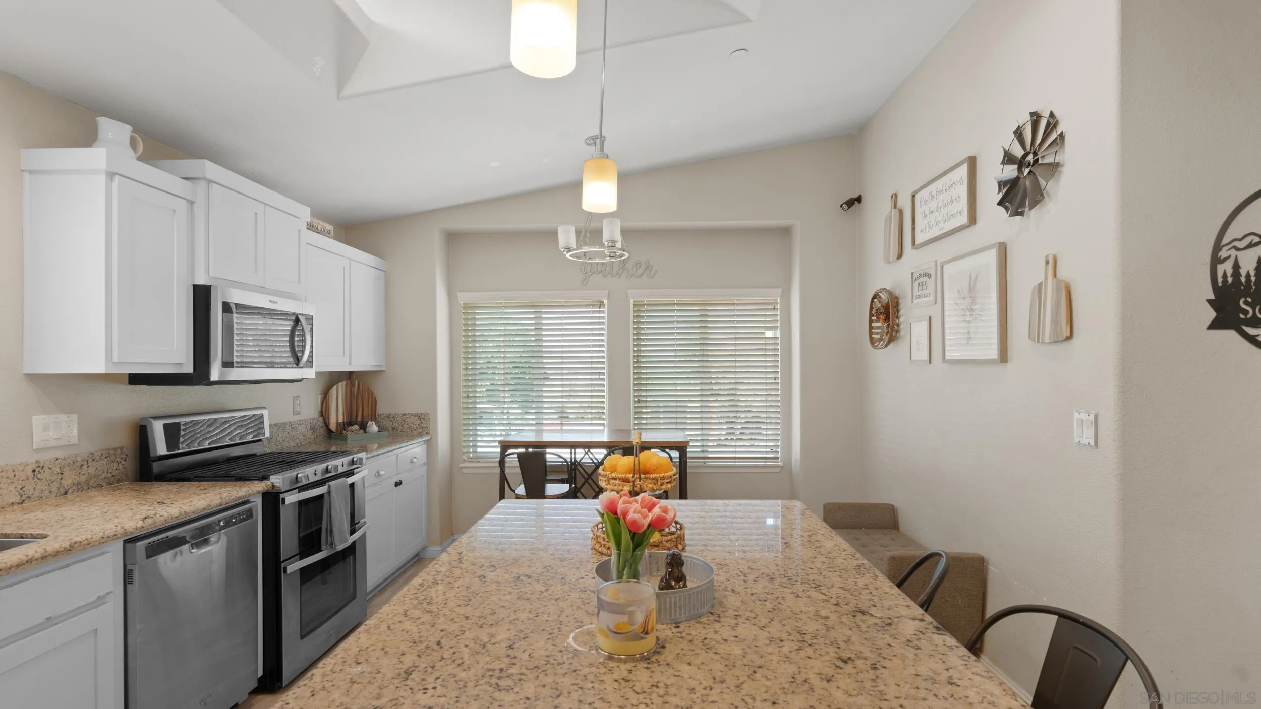 1140 Old Mountain View Road El Cajon, CA 92021 - Photo 3 of 25 a kitchen with stainless steel appliances granite countertop a sink dishwasher a stove top oven a refrigerator with island and chairs with wooden floor