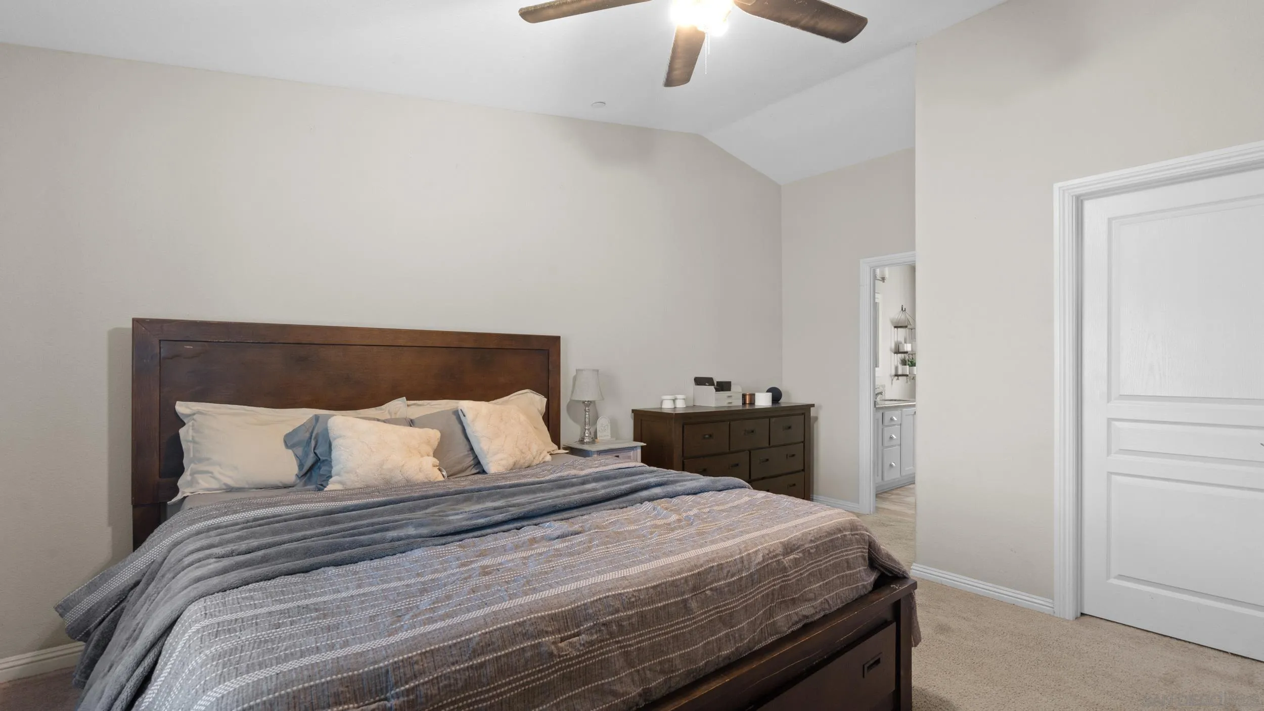 1140 Old Mountain View Road El Cajon, CA 92021 - Photo 10 of 25 a bedroom with a bed and a chandelier