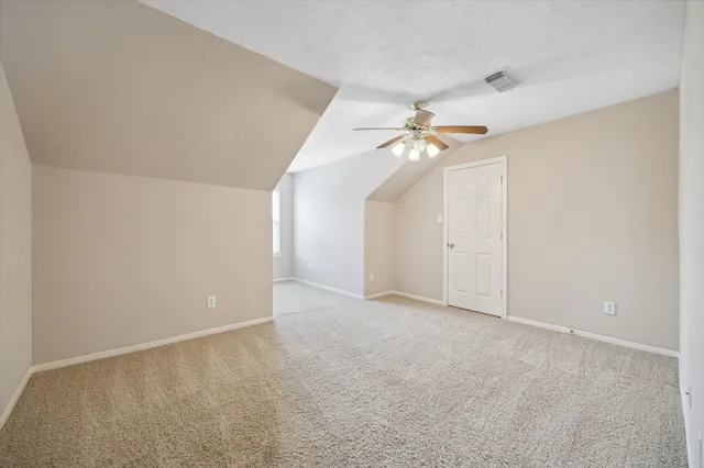 a view of an empty room with a ceiling fan