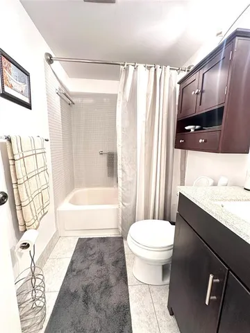 a view of a room and balcony with table and chairs
