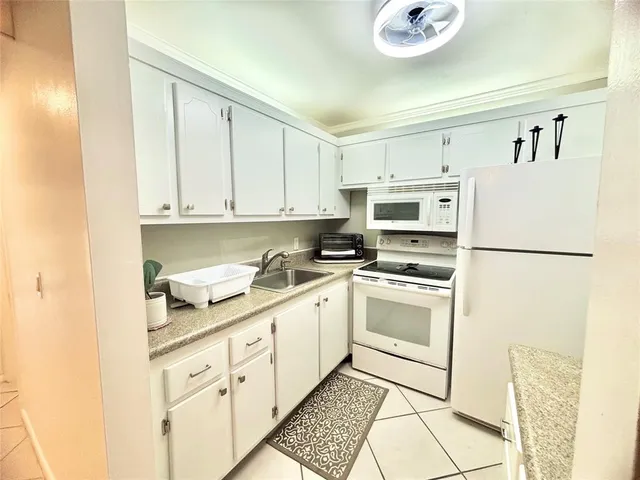 an aerial view of a house with swimming pool and garden