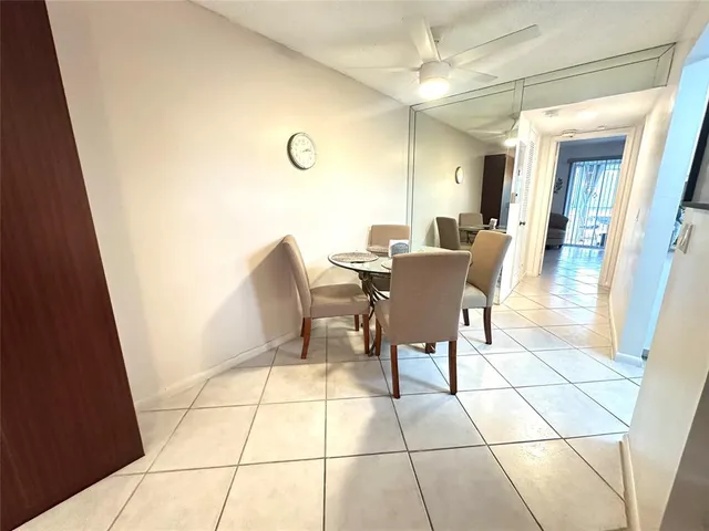 a dining room with furniture and a rug