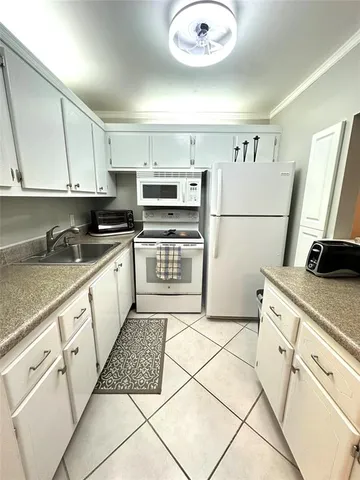 a kitchen with stainless steel appliances granite countertop a refrigerator sink and stove
