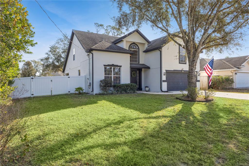 a front view of house with yard and green space