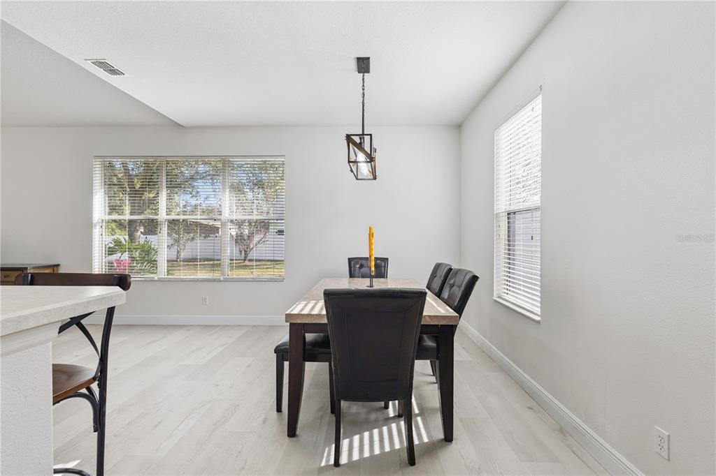 609 Rhodes Drive DeLand, FL 32720 - Photo 13 of 32 a view of a dining room with furniture window and outside view