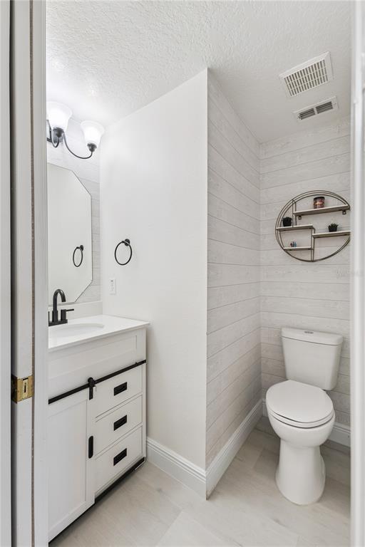609 Rhodes Drive DeLand, FL 32720 - Photo 19 of 32 a bathroom with a toilet sink and mirror