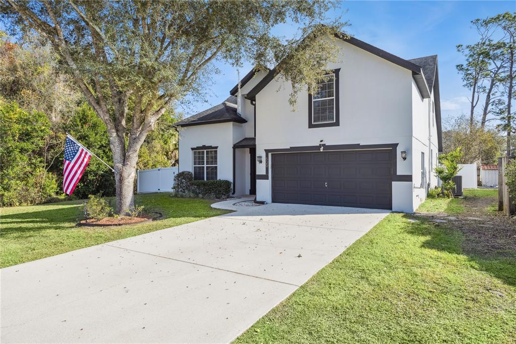 609 Rhodes Drive DeLand, FL 32720 - Photo 2 of 32 a front view of house with yard