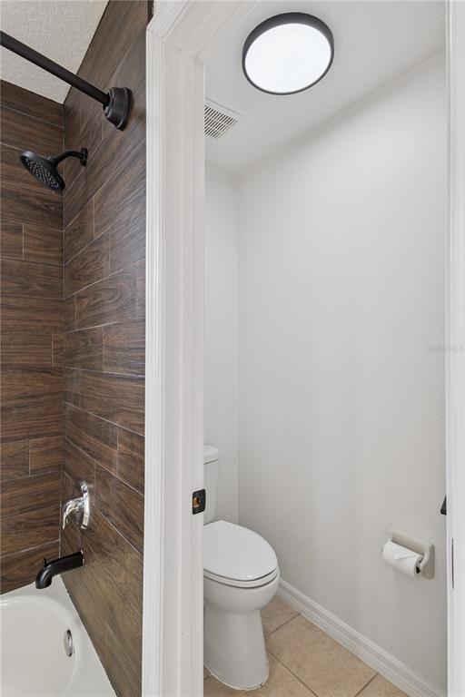 609 Rhodes Drive DeLand, FL 32720 - Photo 26 of 32 a bathroom with a granite countertop toilet and a shower