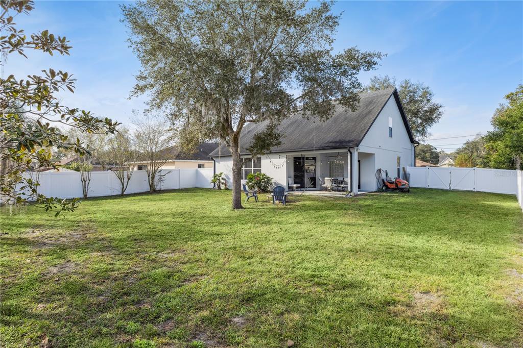 609 Rhodes Drive DeLand, FL 32720 - Photo 31 of 32 a front view of house with yard and seating area
