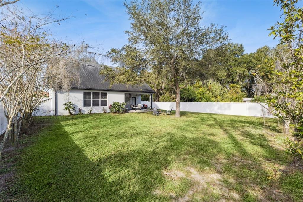 609 Rhodes Drive DeLand, FL 32720 - Photo 32 of 32 a view of a house with a yard and sitting area