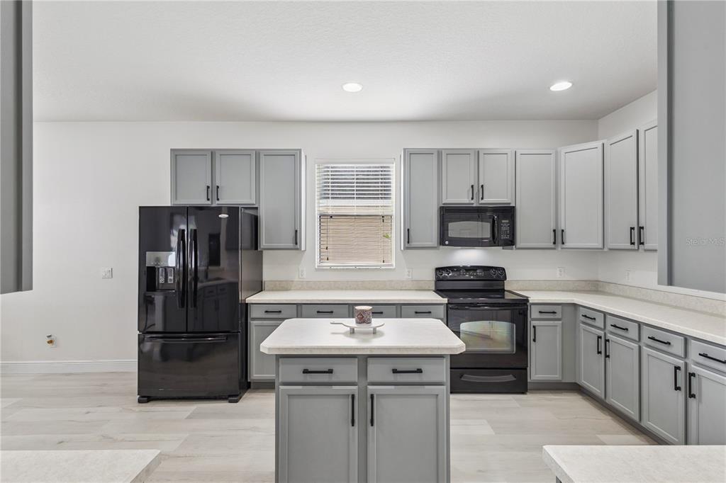 609 Rhodes Drive DeLand, FL 32720 - Photo 8 of 32 a kitchen with a sink appliances and cabinets