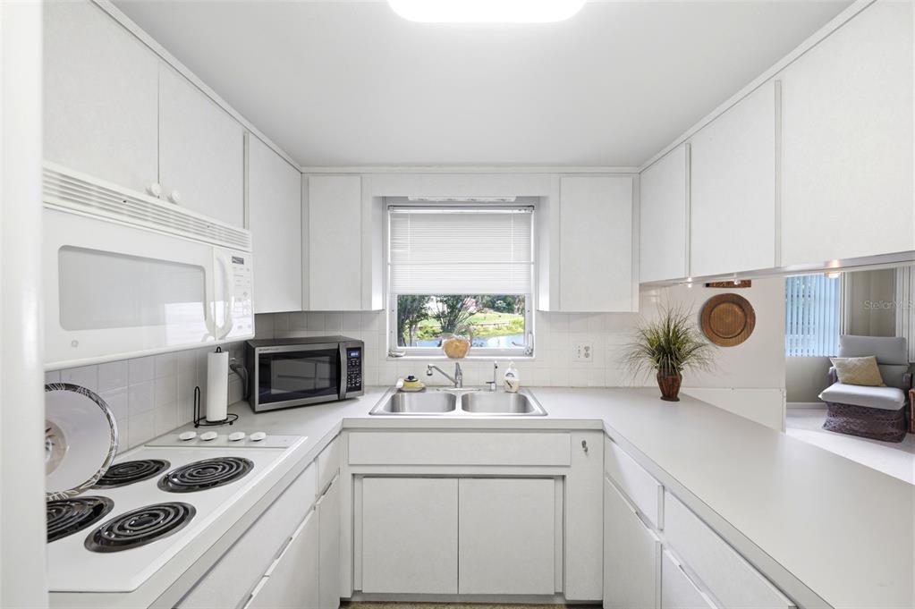 1830 South Mandarin Terrace Inverness, FL 34450 - Photo 13 of 47 a kitchen with a sink a stove and cabinets