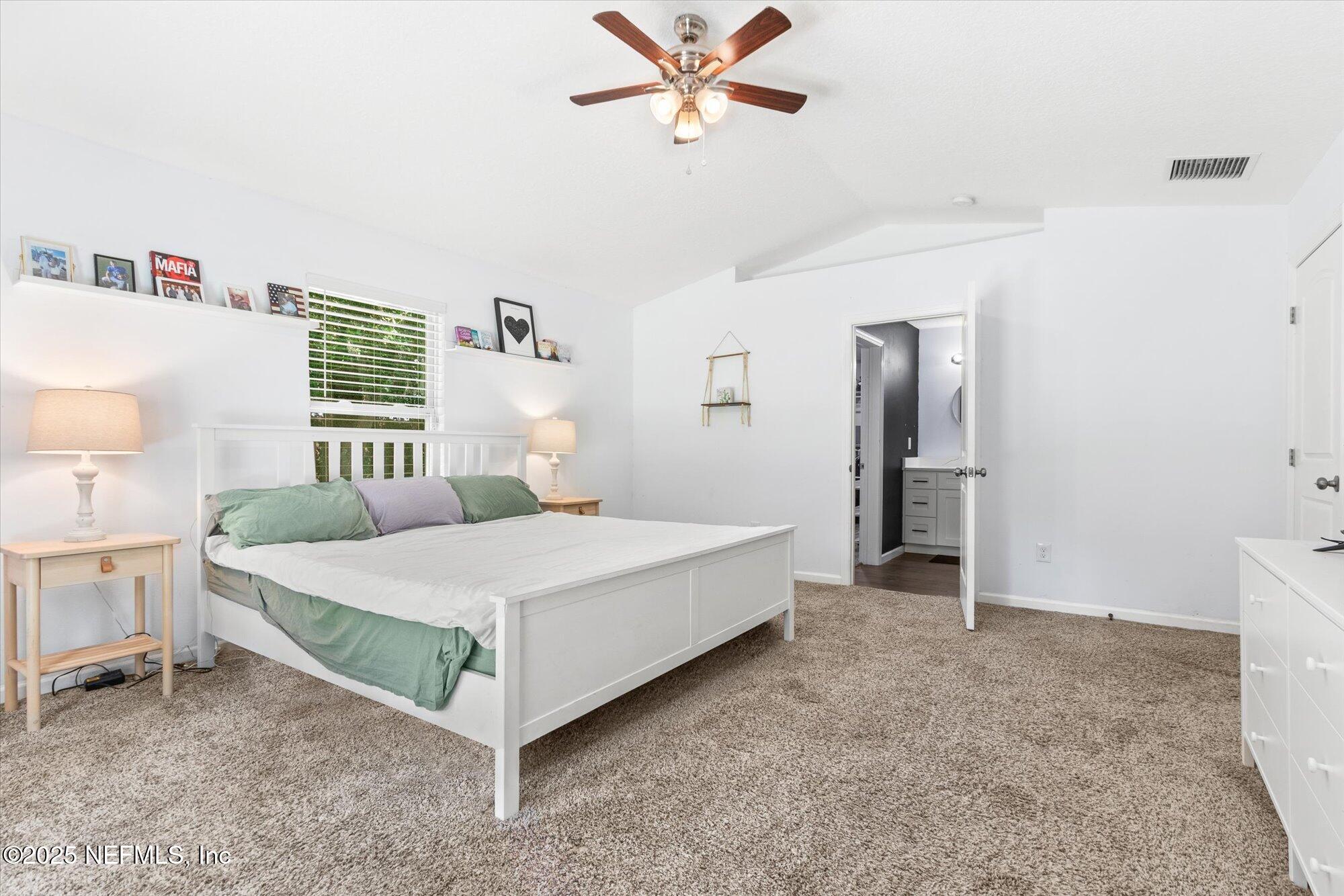 3615 Weaver Road Palatka, FL 32177 - Photo 16 of 30 a bedroom with a bed and a chandelier