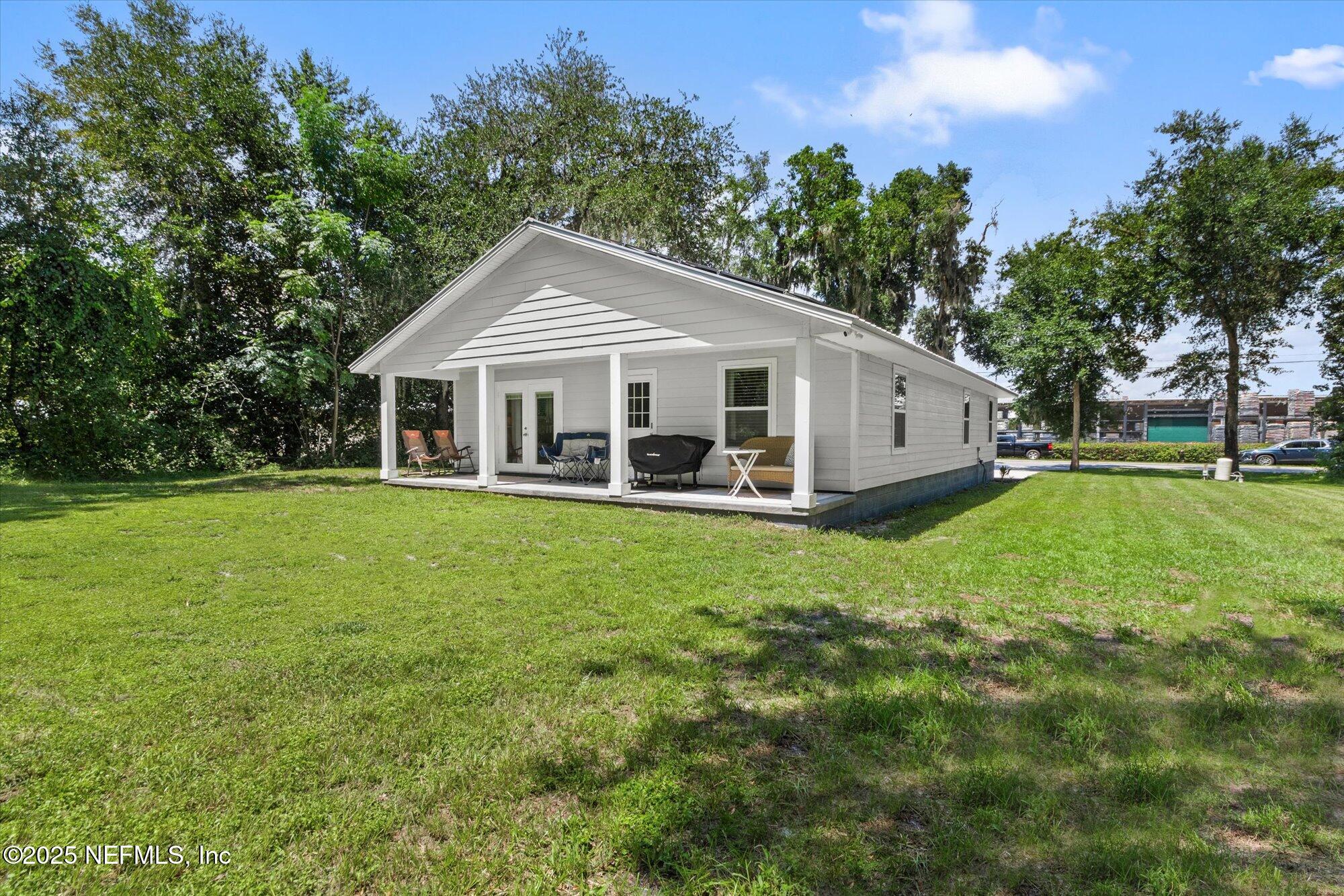 3615 Weaver Road Palatka, FL 32177 - Photo 26 of 30 a front view of a house with a garden and trees