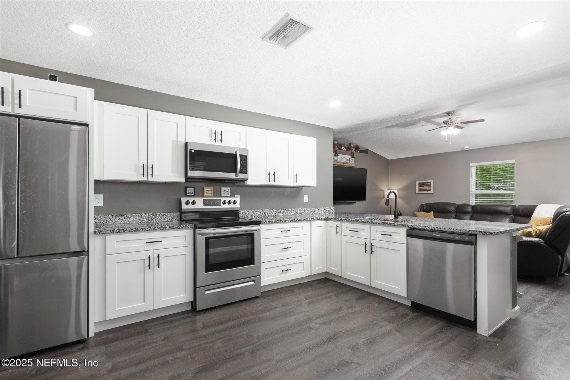3615 Weaver Road Palatka, FL 32177 - Photo 7 of 30 a kitchen with granite countertop appliances cabinets and a sink