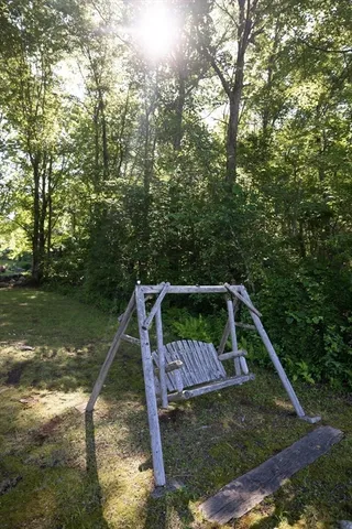 a wooden deck with trees in the background