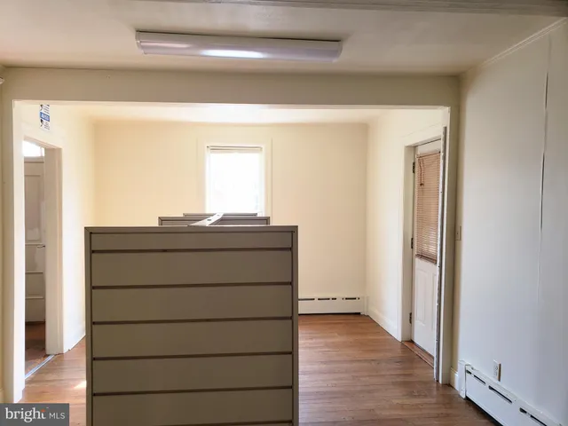 a view of room with wooden floor