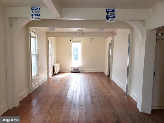 a view of a livingroom with wooden floor and window