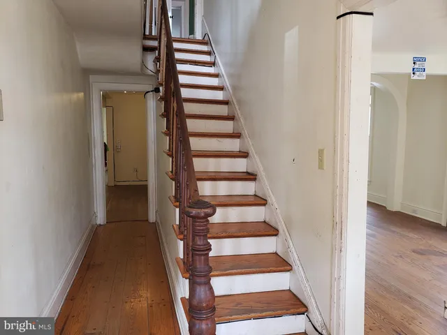 a view of entryway with wooden floor and stairs