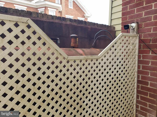 a view of a black building with a black white checkered door