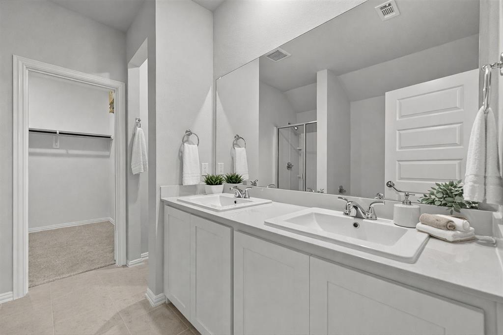 1504 Foxglove Van Alstyne, TX 75495 - Photo 5 of 12 a bathroom with double sink and a mirror