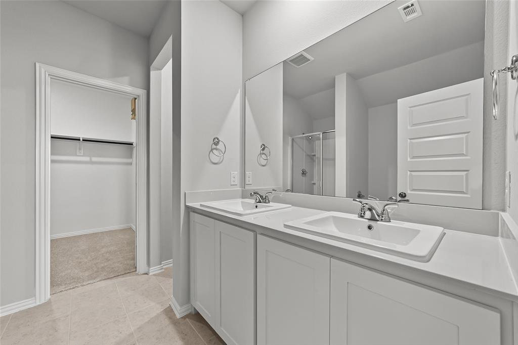 1504 Foxglove Van Alstyne, TX 75495 - Photo 8 of 12 a bathroom with 2 sink and a mirror