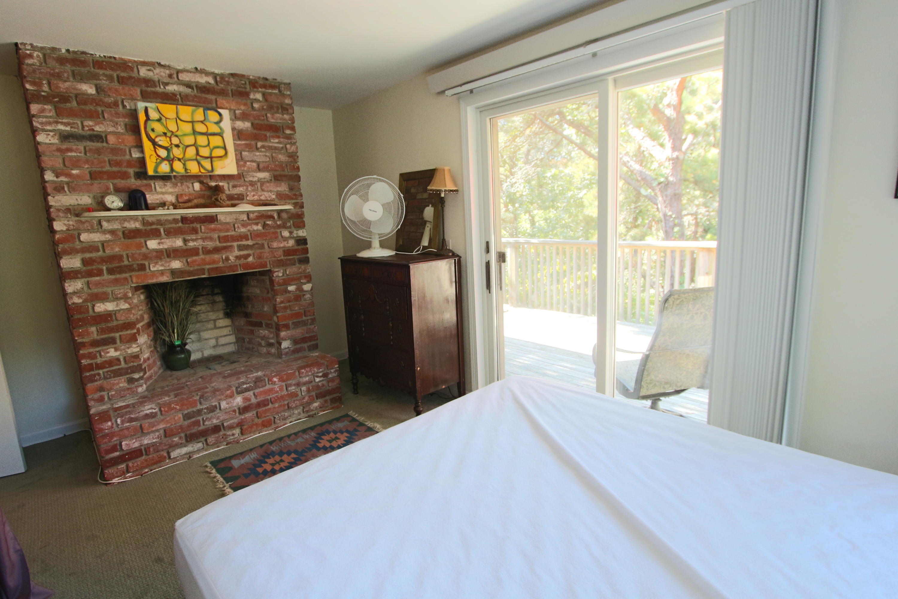 26 Fishermans Road Truro, MA 02666 - Photo 11 of 29 a bedroom with a bed and a fireplace