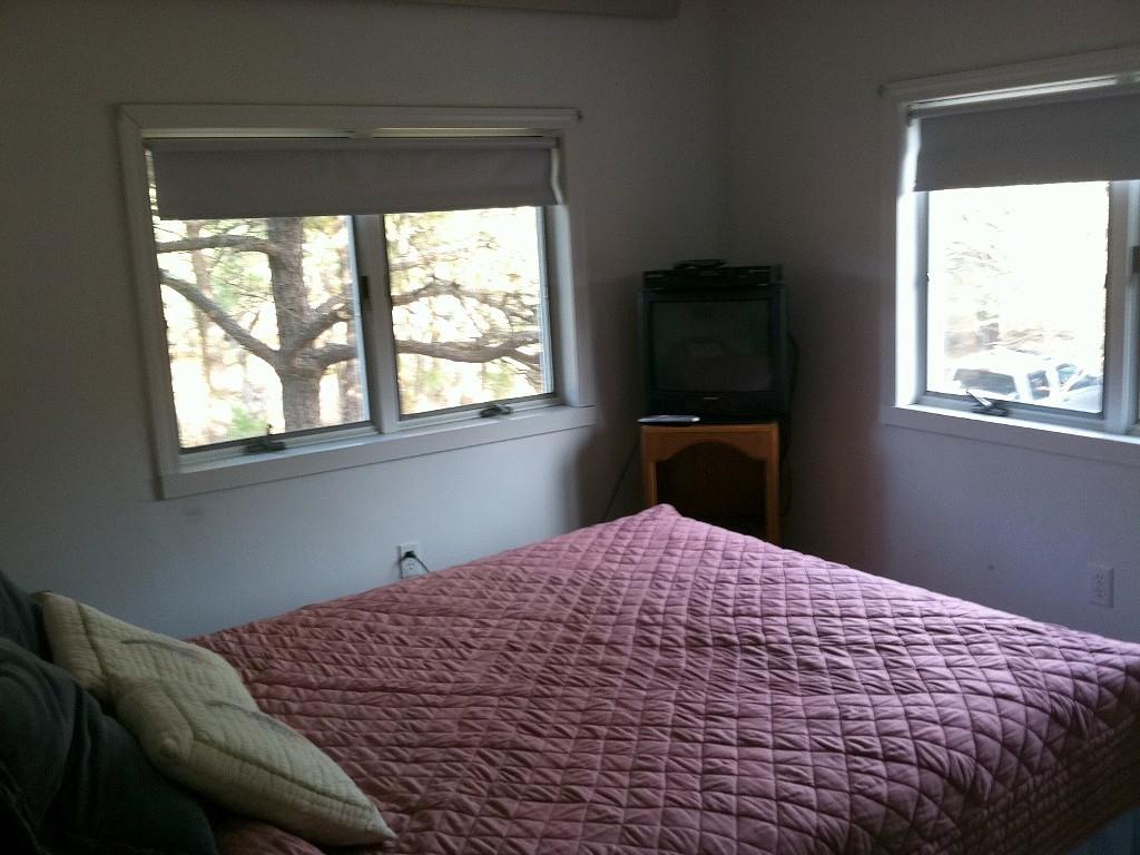26 Fishermans Road Truro, MA 02666 - Photo 13 of 29 a bedroom with a bed and a window