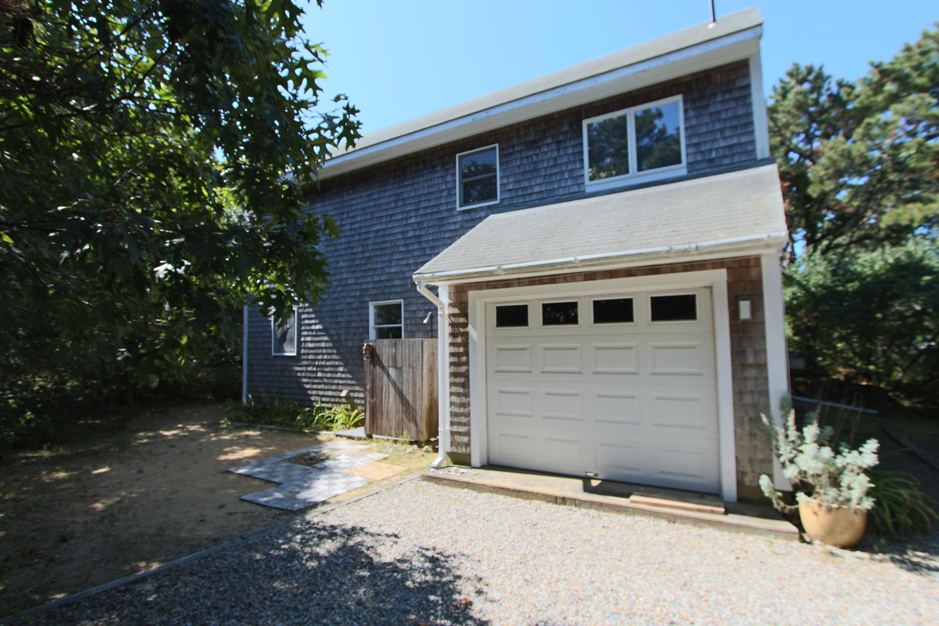 26 Fishermans Road Truro, MA 02666 - Photo 3 of 29 a front view of a house with a yard