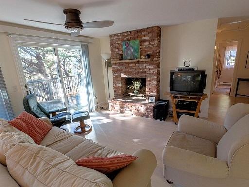 26 Fishermans Road Truro, MA 02666 - Photo 4 of 29 a living room with furniture a flat screen tv and a fireplace